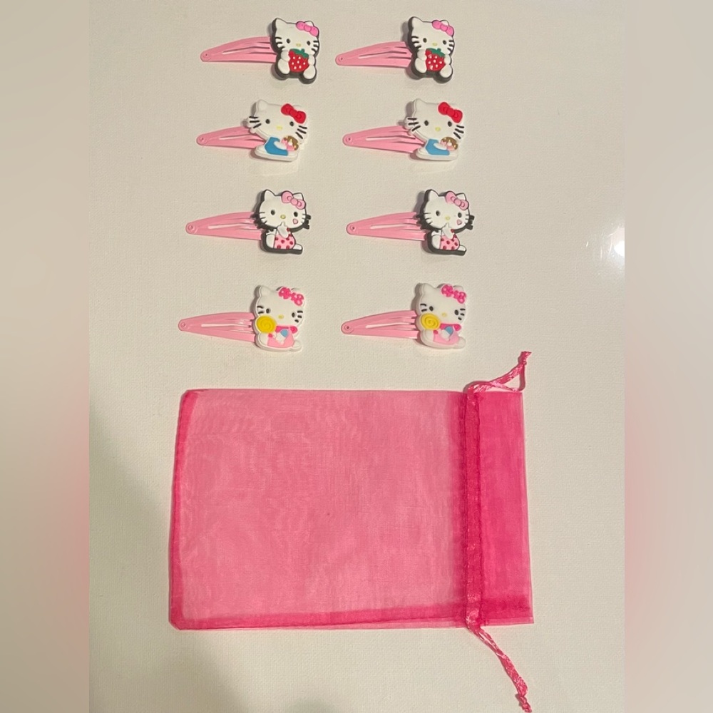 Hello Kitty 8pc hair barrette set with dust bag.